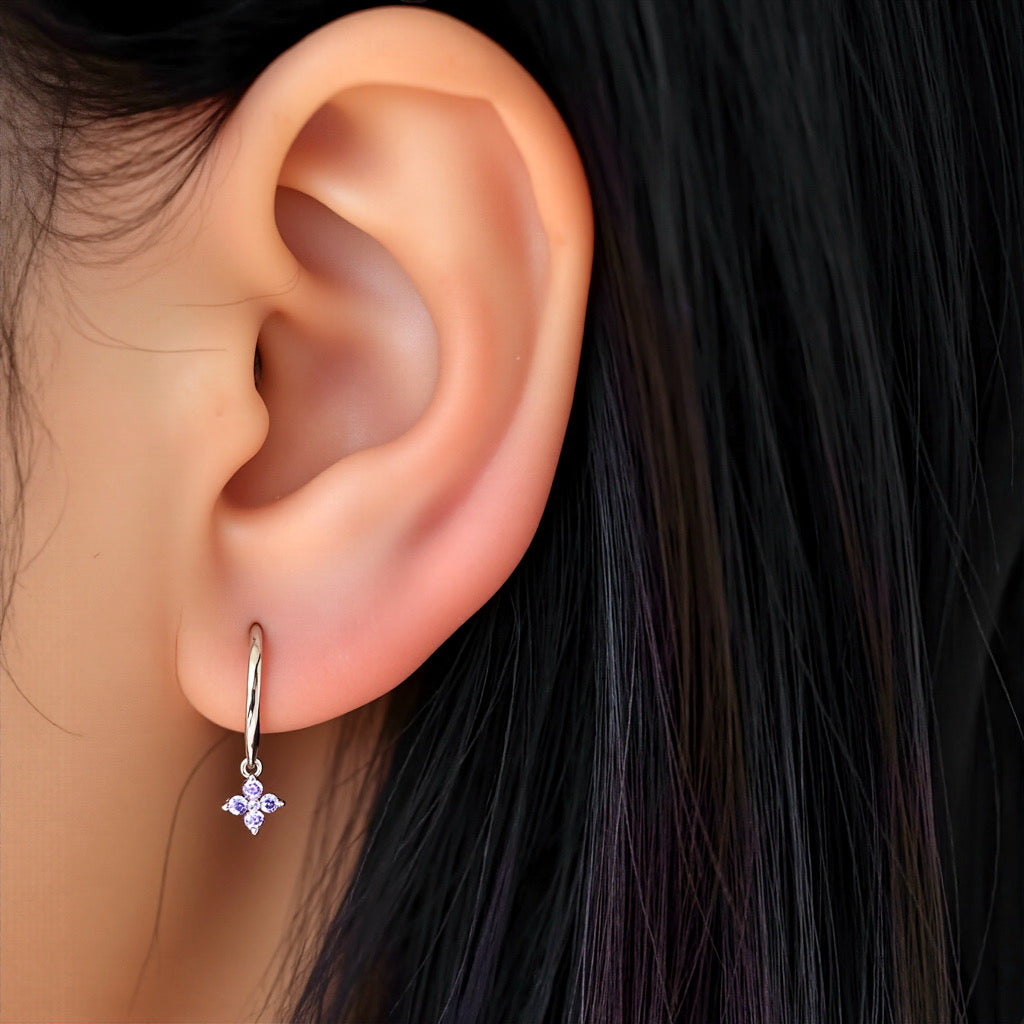 Model wearing PaulaB sterling silver rhodium hoop earrings with purple gemstone - Sydney fashion jewellery.