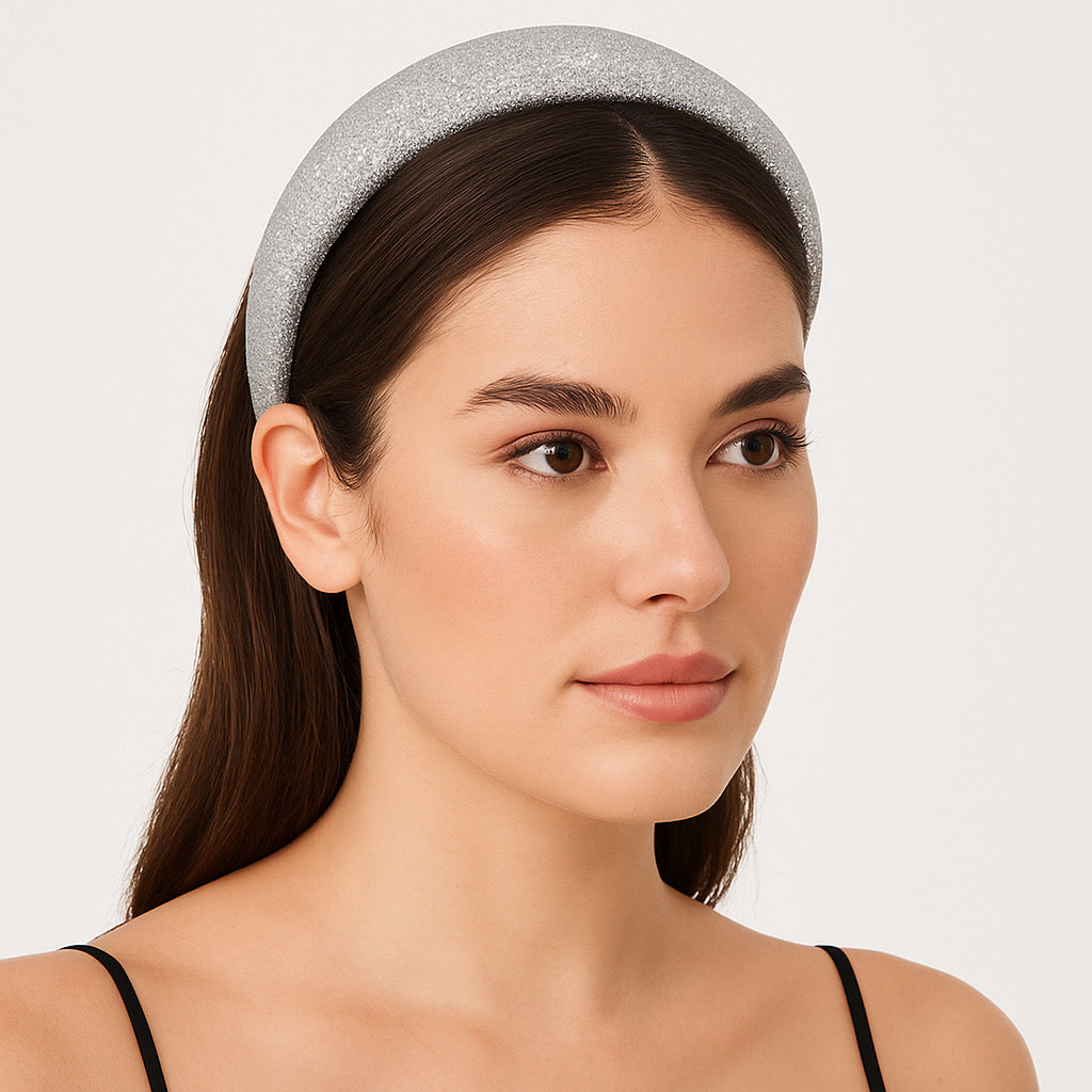 Studio model wearing PaulaB silver glitter padded crown headband.