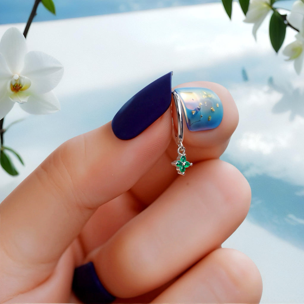 Close-up of PaulaB sterling silver rhodium hoop earrings with green gemstone held in hand - Sydney Australia.