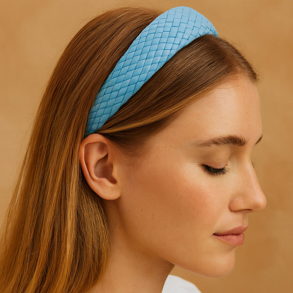 close-up of women wearing sky blue PU leather braided headband woven detail fashion accessory.