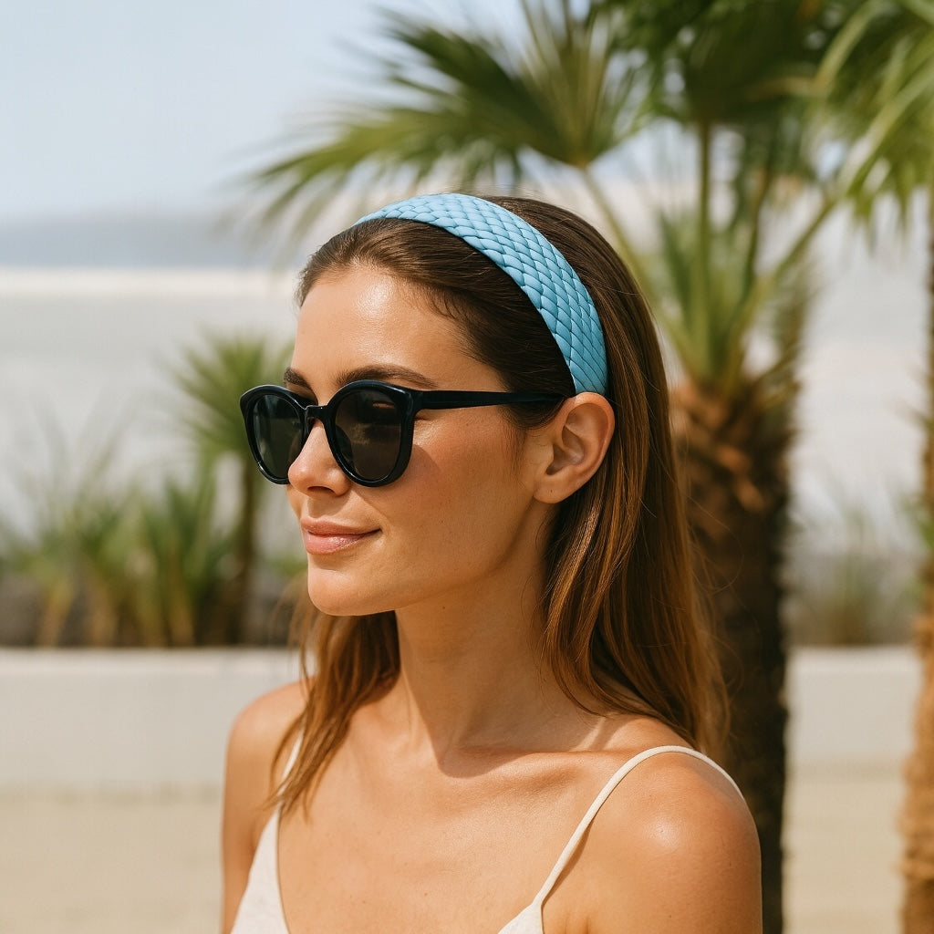 Model wearing sky blue PU leather braided headband with sunglasses tropical chic style.