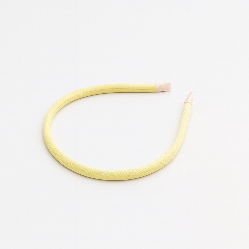 Close up lay flat of PaulaB soft cotton thin headband, slim cotton fabric with thin sponge padding