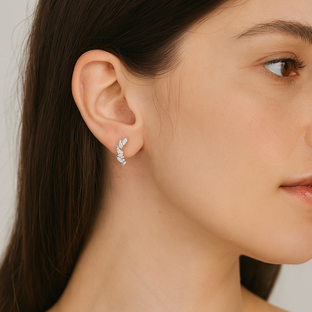 Pretty model wearing PaulaB sterling silver rhodium plated earrings, 1.3cm close up, elegant ear climber style -Sydney and New Zealand fashion accessories.