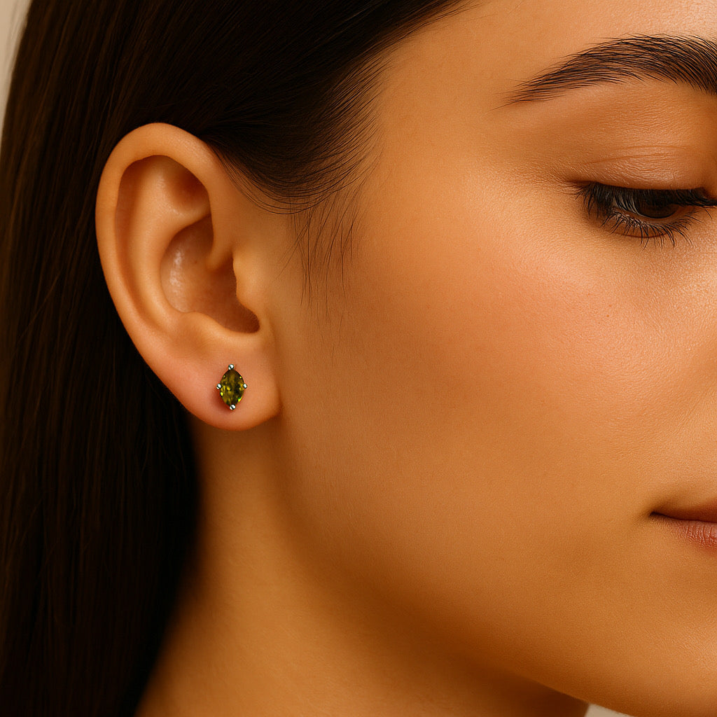 Model wearing PaulaB rhodium sterling silver earrings with marquise green, emerald cubic stones, chic jewellery for woman in Sydney Australia.