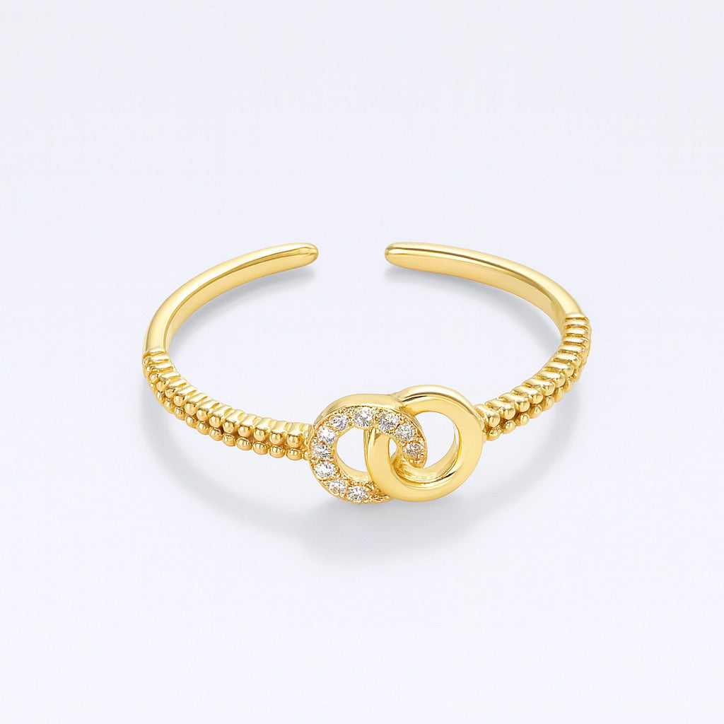 Cloe-up of PaulaB adjustable gold-plated sterling silver knot ring with cubic zirconia.