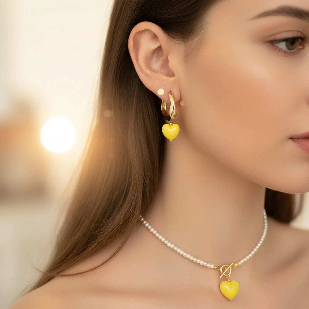 Model wearing PaulaB Sunshine Yellow Heart Earrings and matching Necklace with gold plated finish, delicate pearl details Australia NZ.