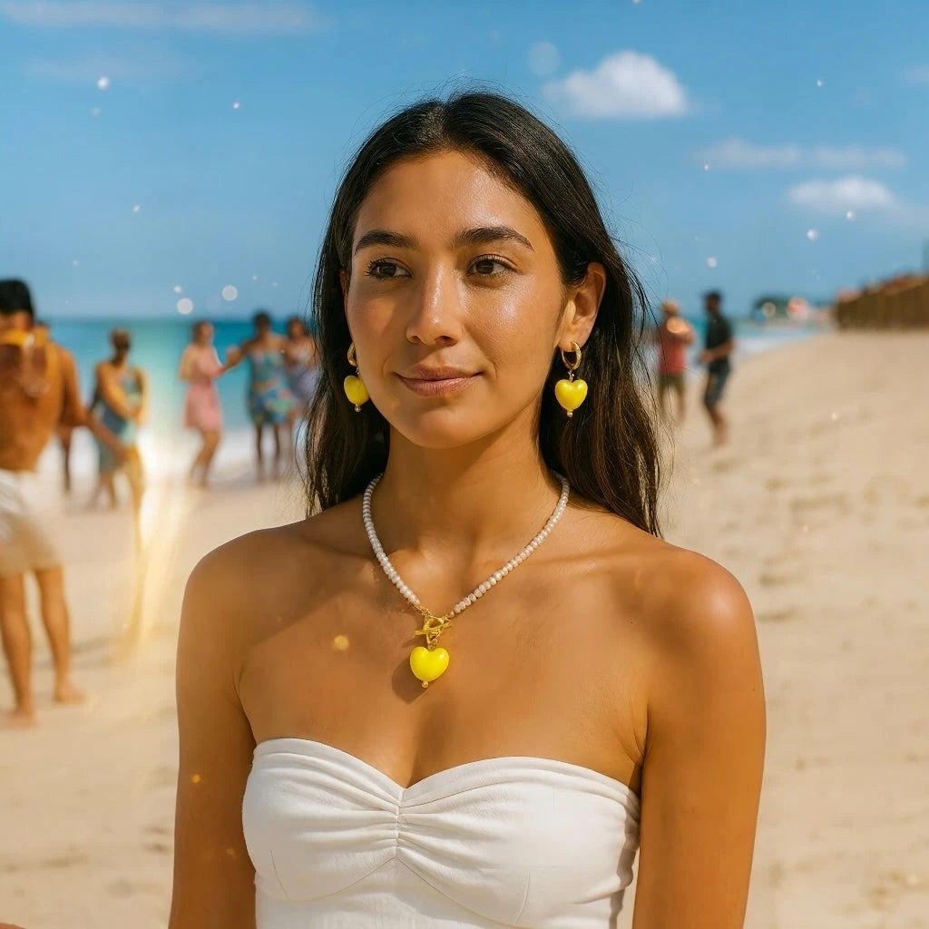 Women wearing PaulaB Sunshine Yellow Heart Necklace and Earrings at beach party under sunshine, summer fashion jewellery Australia and New Zealand.