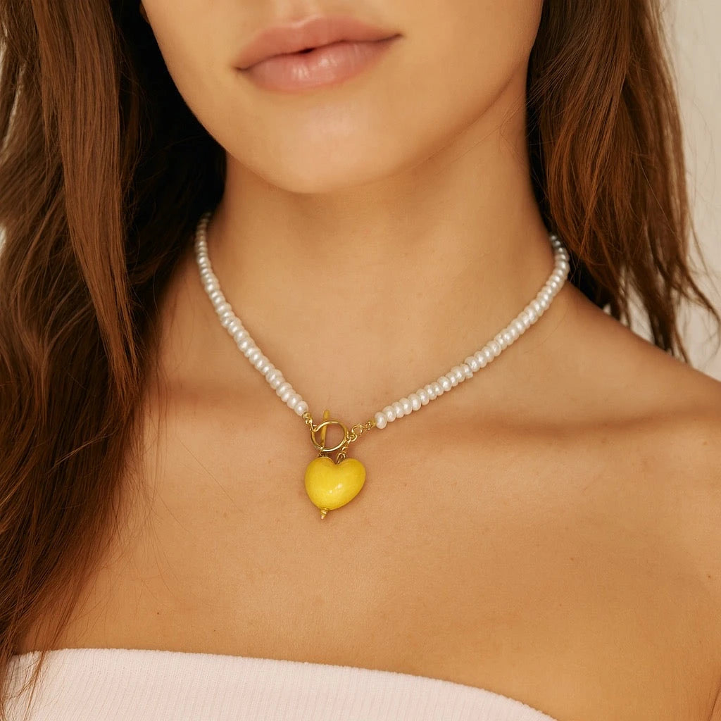 Model wearing PaulaB Sunshine Yellow Heart Necklace showing close-up of pearls and 14k gold-plated toggled clasp, elegant, handcrafted jewellery NZ Australia.