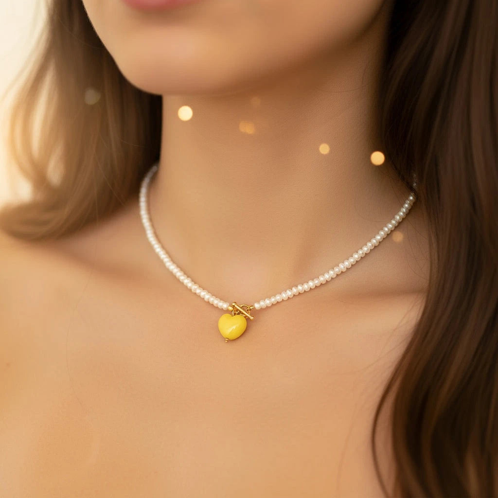 PaulaB handcrafted freshwater pearl necklace with sunshine yellow heart pendant photographed in soft light, designed in Sydney Australia.