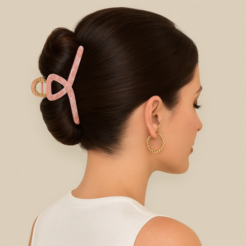 Brunette model with sleek French twist wearing pink and gold hair claw clip.
