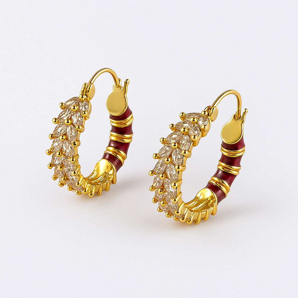Studio shot of Radiant Rouge & Crystal Marquise Hoop Earrings in 18k gold plating with crimson enamel and marquise-cut zirconia stones