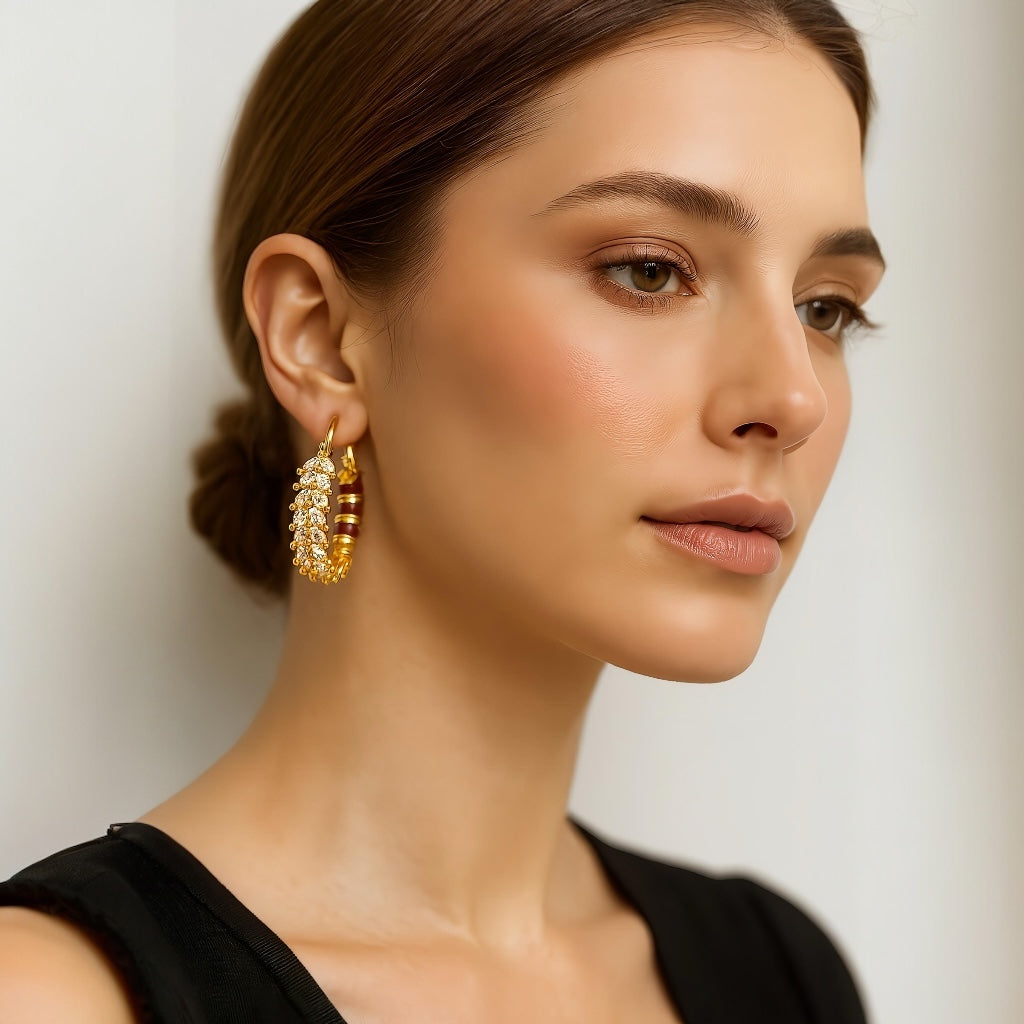 Side profile of model wearing Radiant Rouge & Crystal Marquise Hoop Earrings featuring crimson enamel and sparkling marquise-cut zirconia