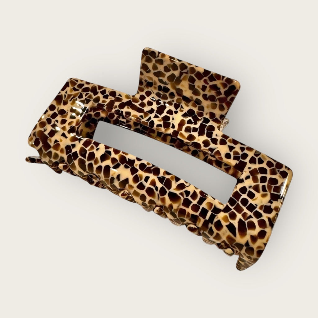 Savannah Luxe haor claw clip in caramel and espresso animal print on soft neutral background.