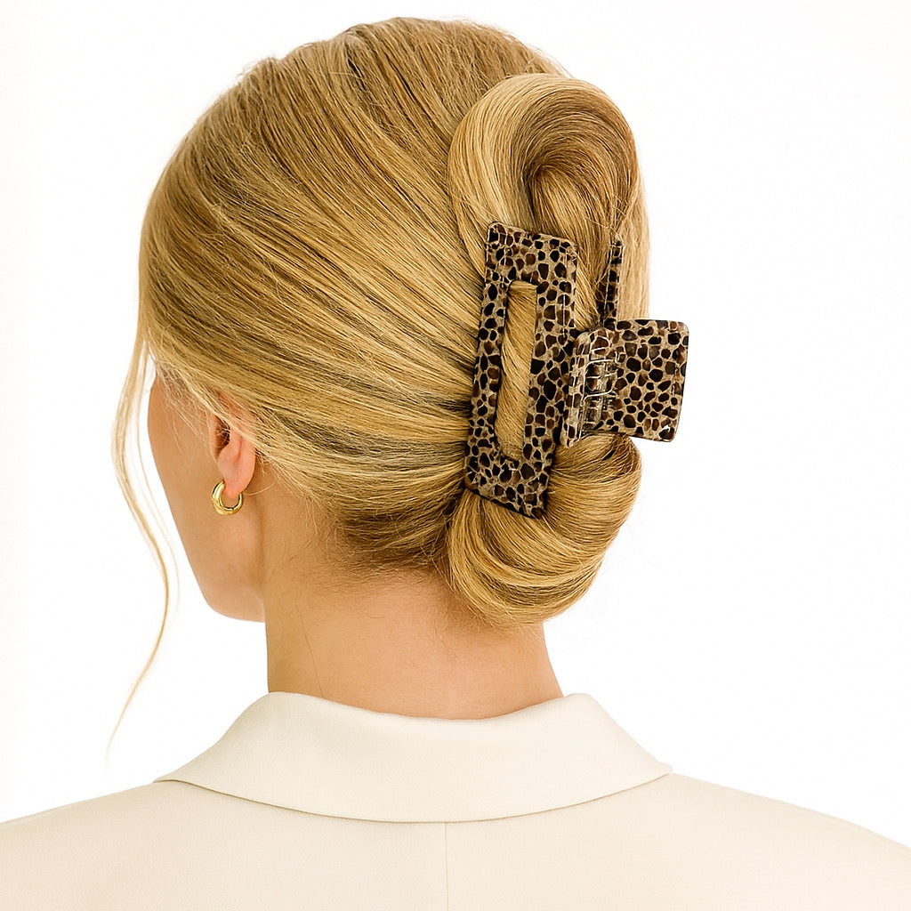 Blonde model in ivory blazer wearing Savannah Luxe animal print hair claw in French twist.