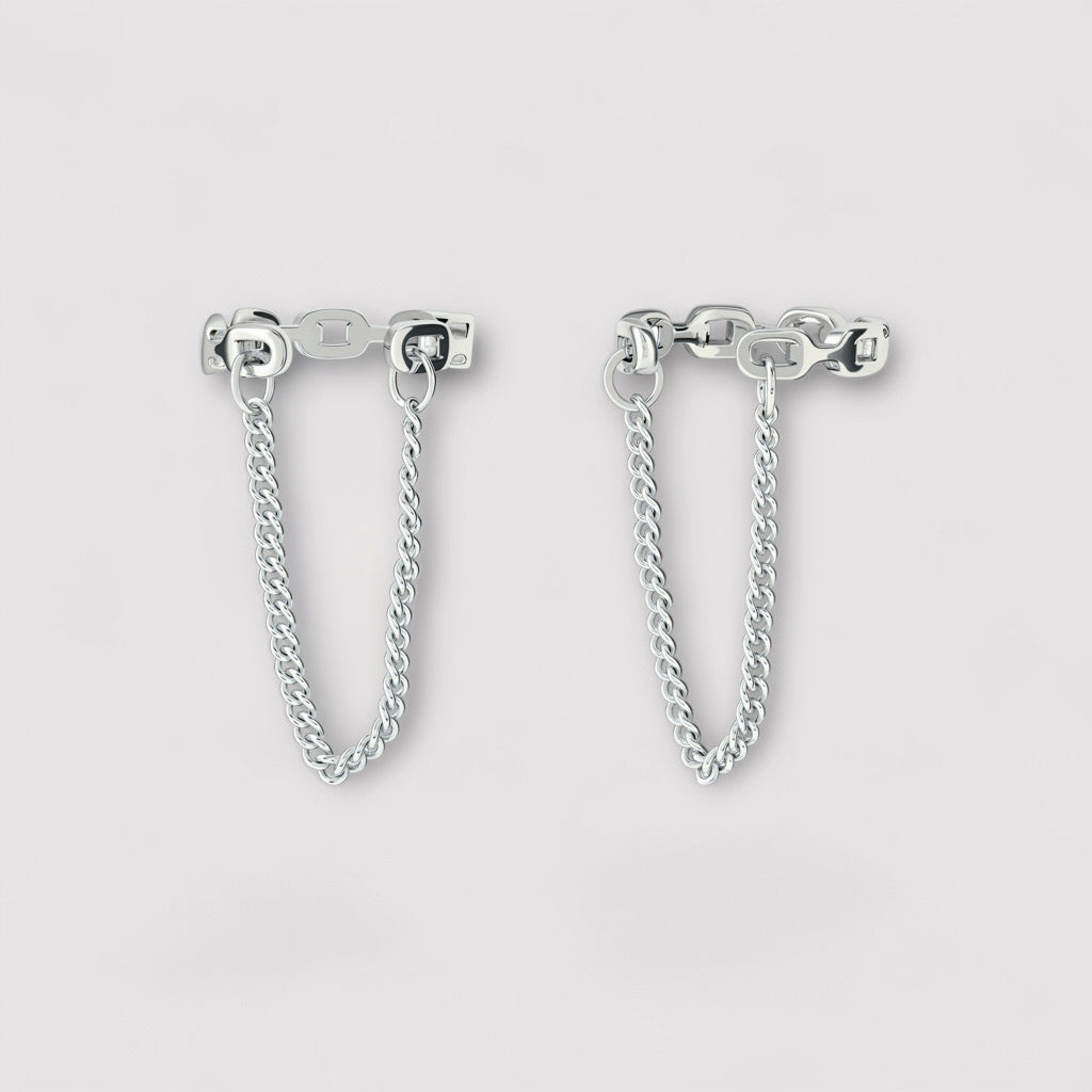 Studio shot of sterling silver cuff chain earrings with minimalist double cuff and connecting chain