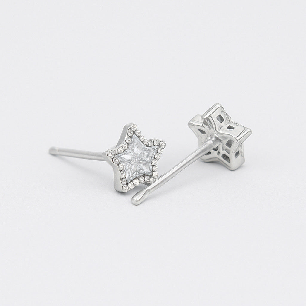 Side view of sterling silver star earrings with rhodium plating and cubic zirconia crystal - PaulaB Accessories.