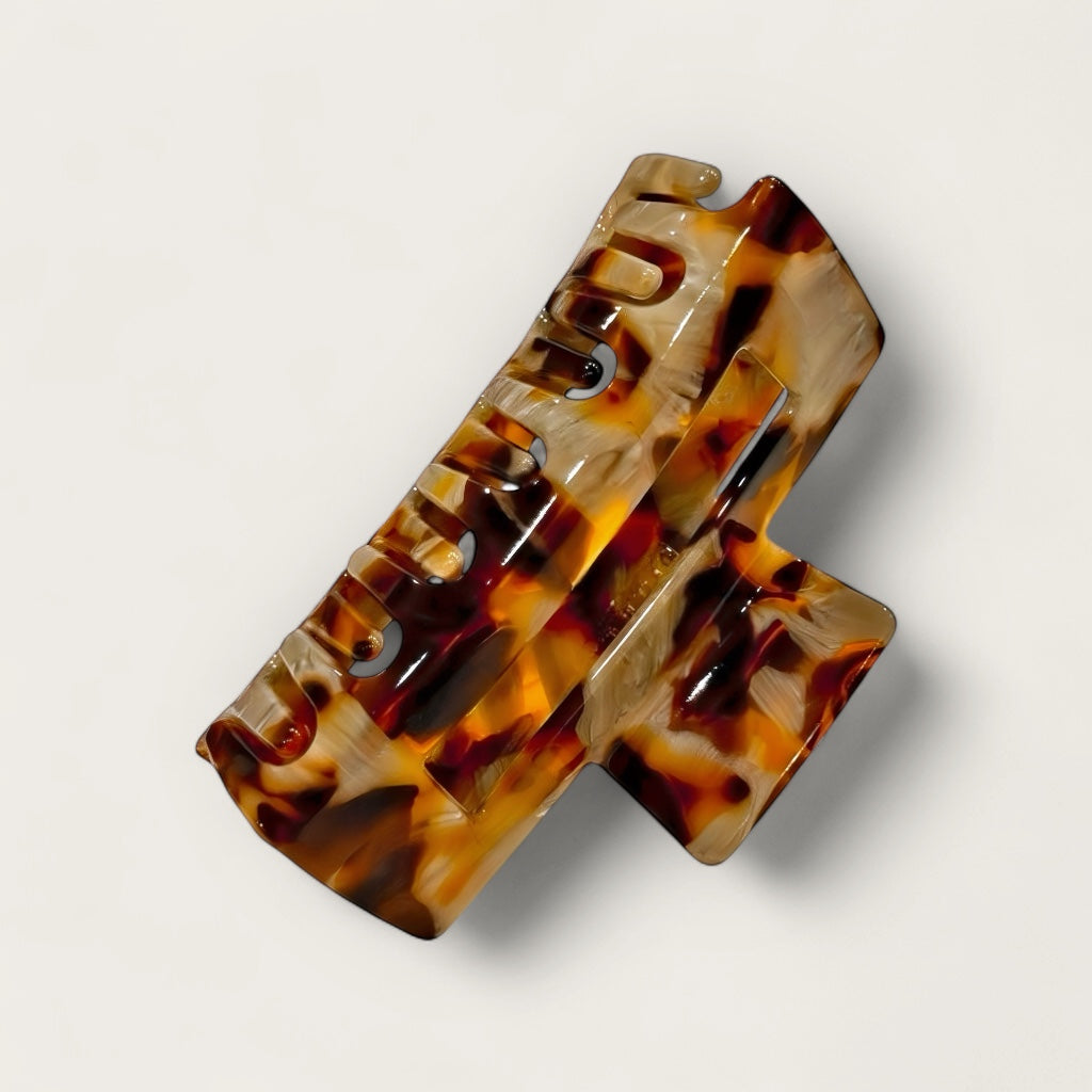 Underside view of tortoise claw clip showing grip teeth.